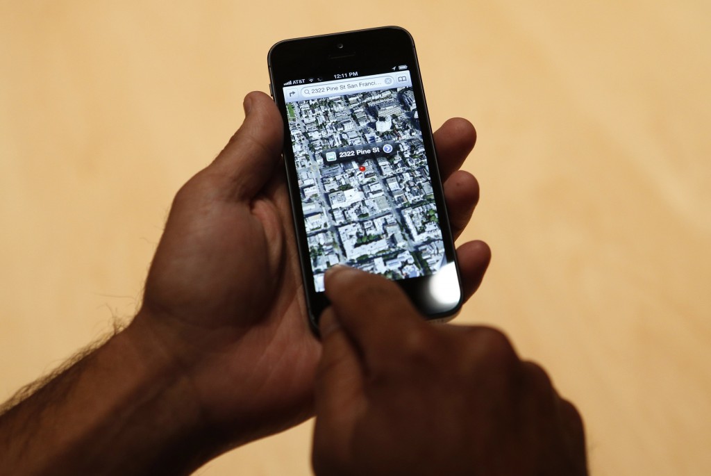 File photo of a member of the media using the map function of iPhone 5 after its introduction during Apple Inc.'s iPhone media event in San Francisco