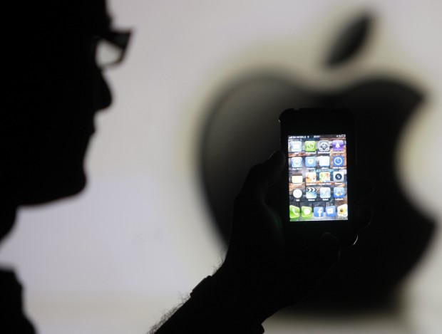File photo illustration of a man posing with Apple iPhone 4 smartphone in Zenica